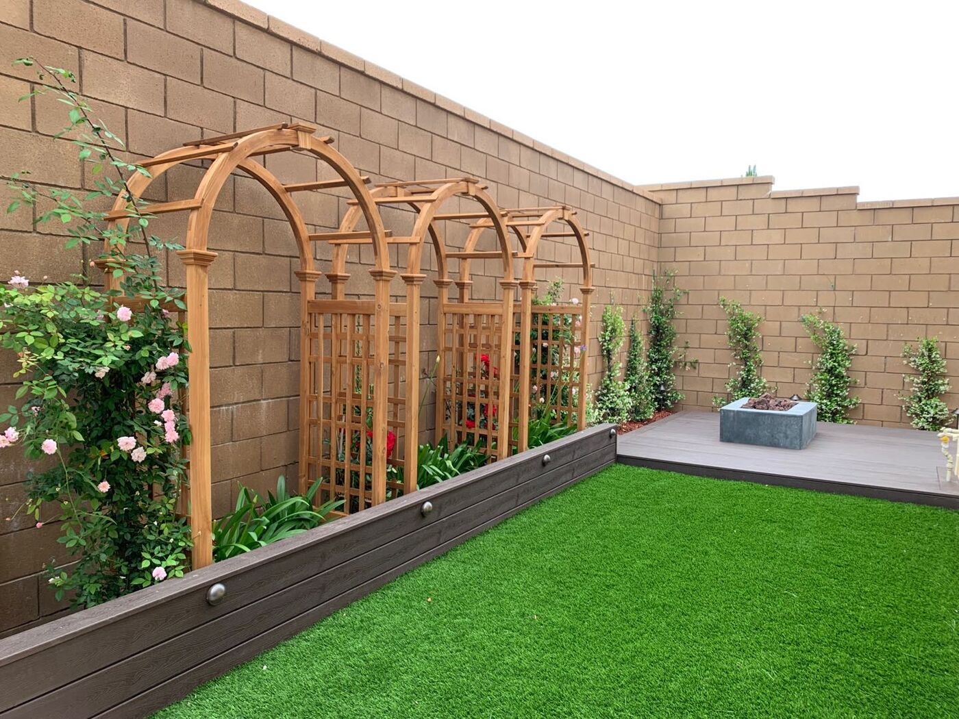 Rose arches along a lawn