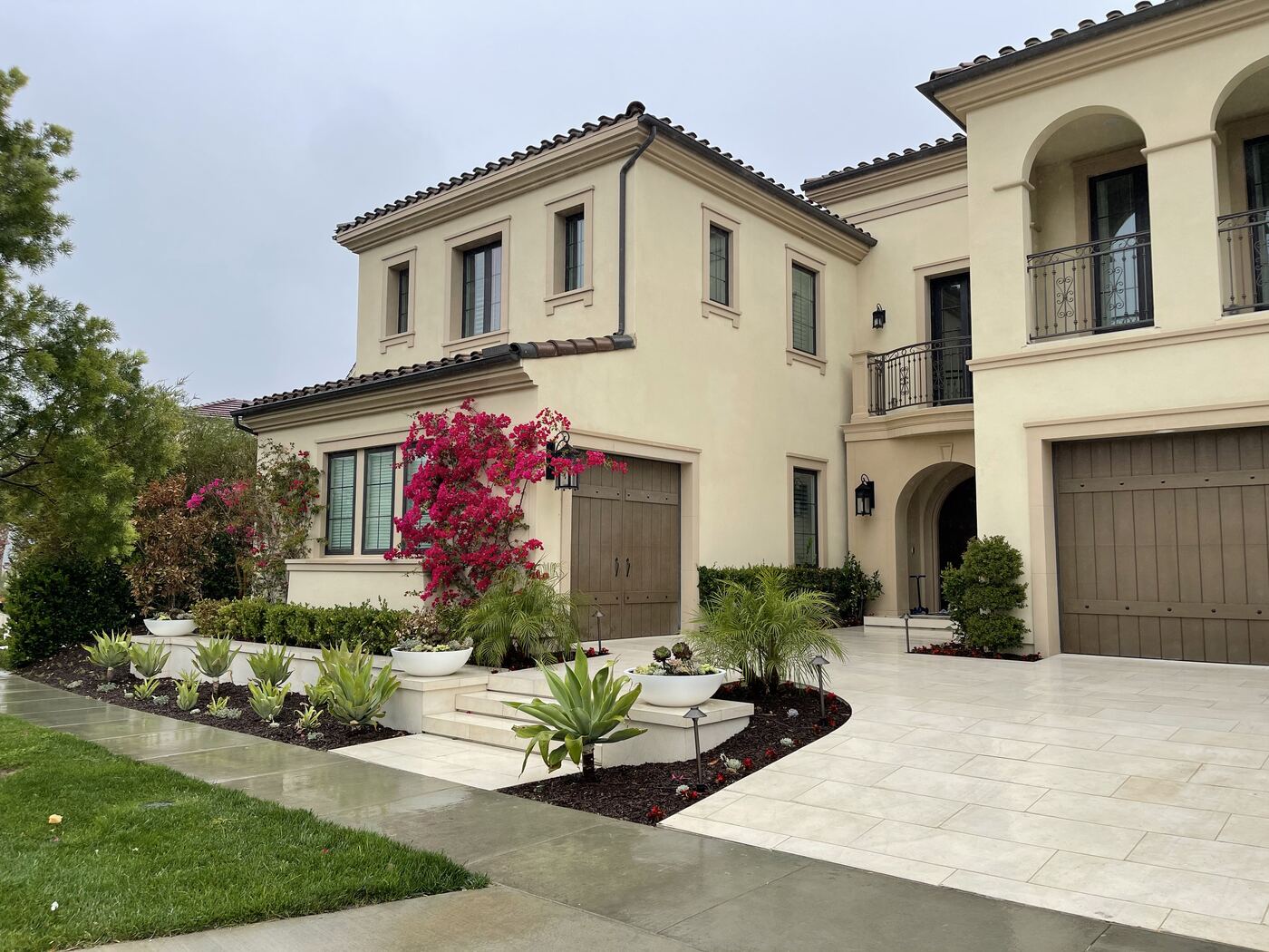 Mediterranean home with layered front garden