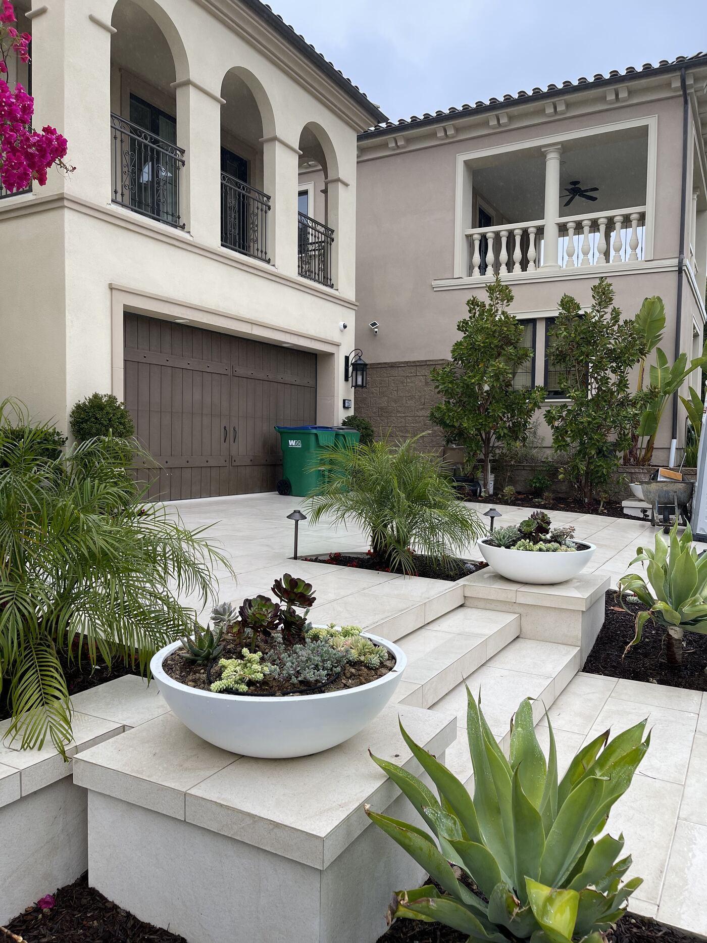 Entry steps flanked by bougainvillea