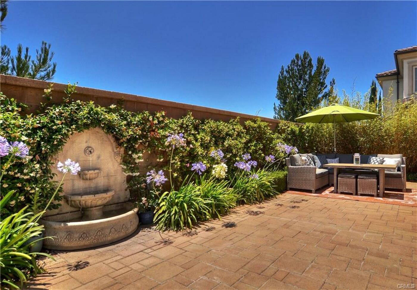 Stone fountain in a flower border