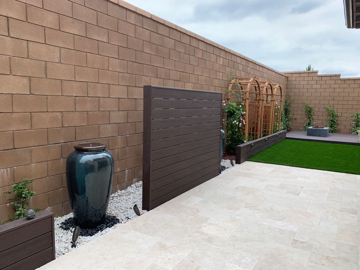 Glazed vase beside arbor wall