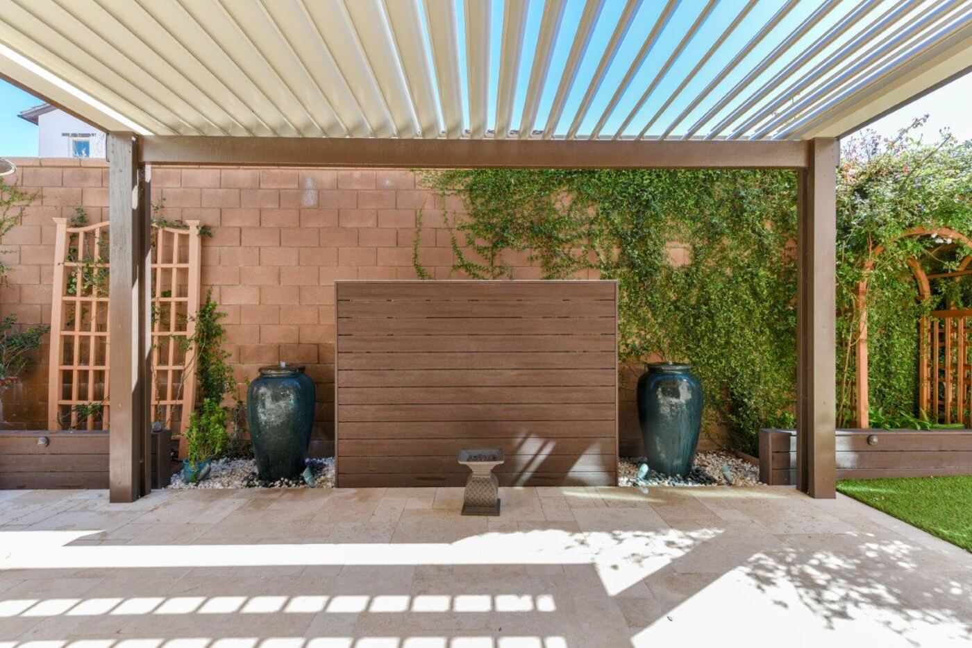 Louvered pergola over a dining patio