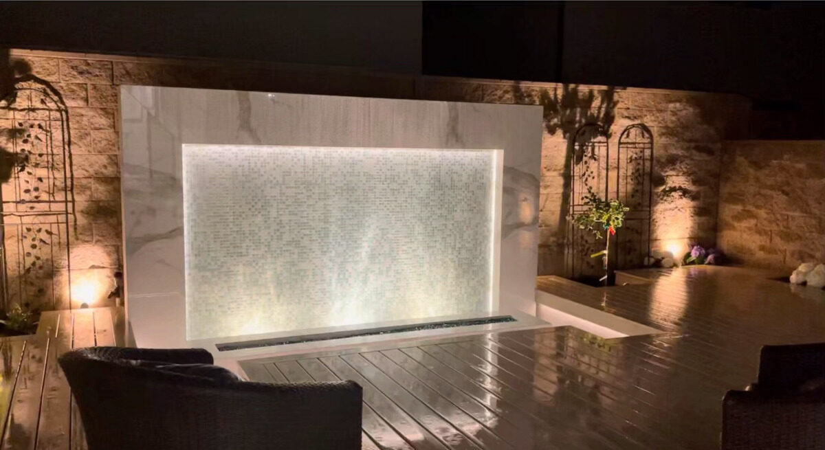 Marble water wall and pool at night — frame from the V&J film